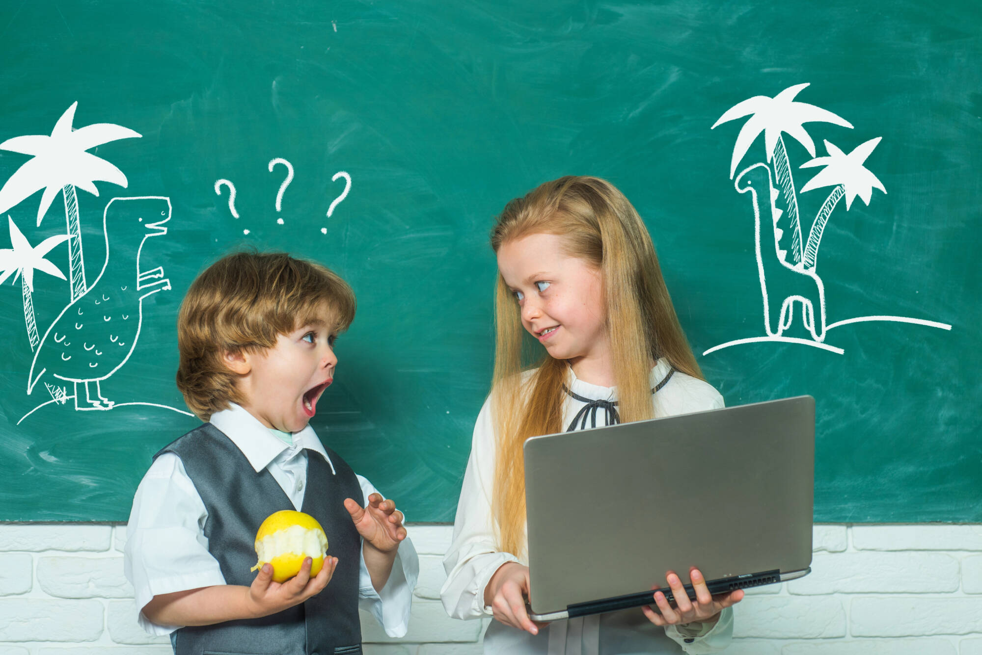Boy and girl in school interested in learning
