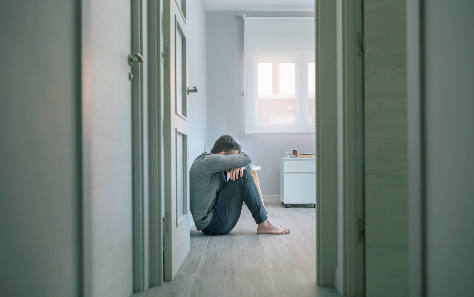 Depression, man sitting on the floor himself