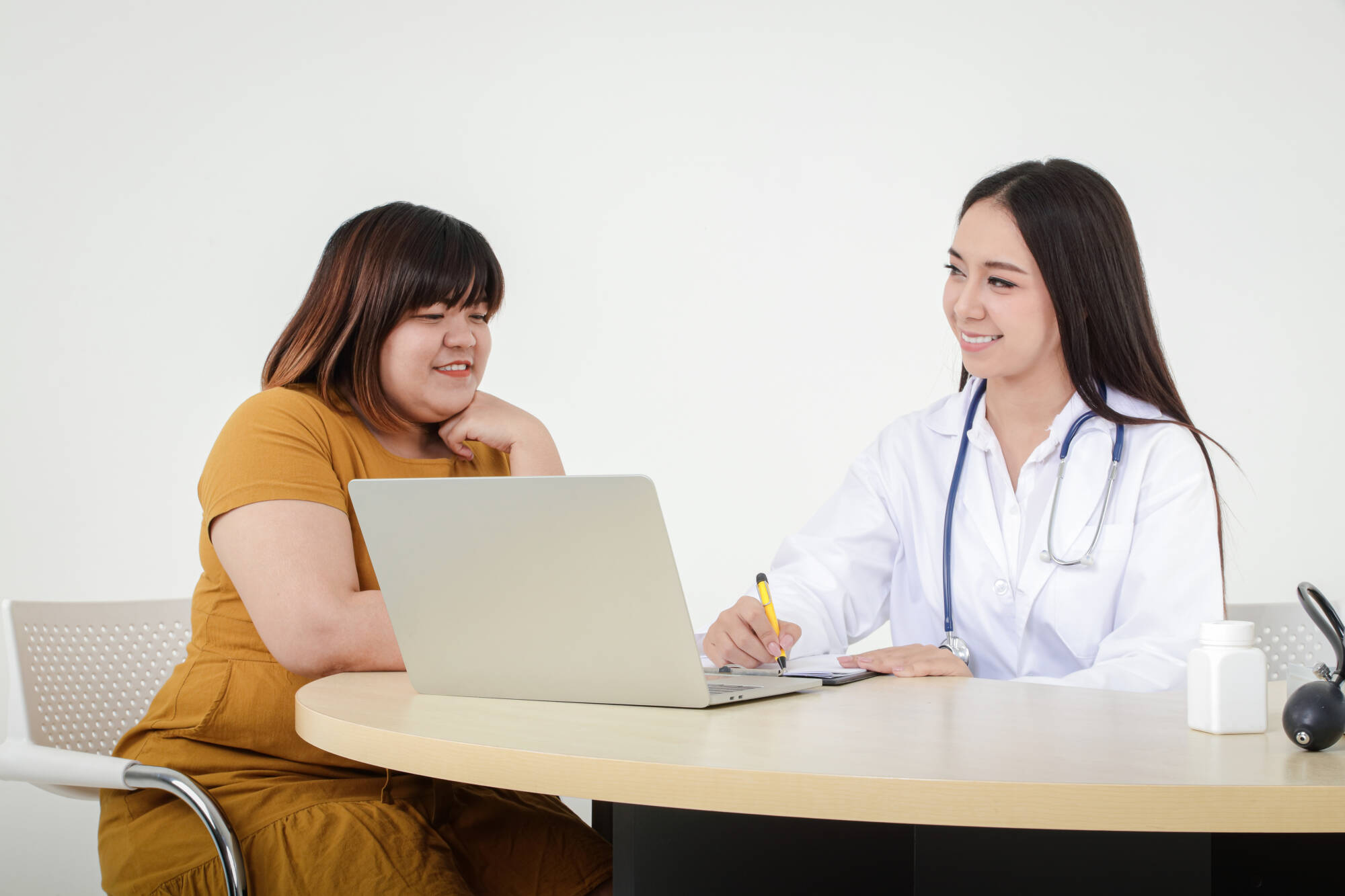 Weight loss Doctor discussing a medical plan with an obese patient.